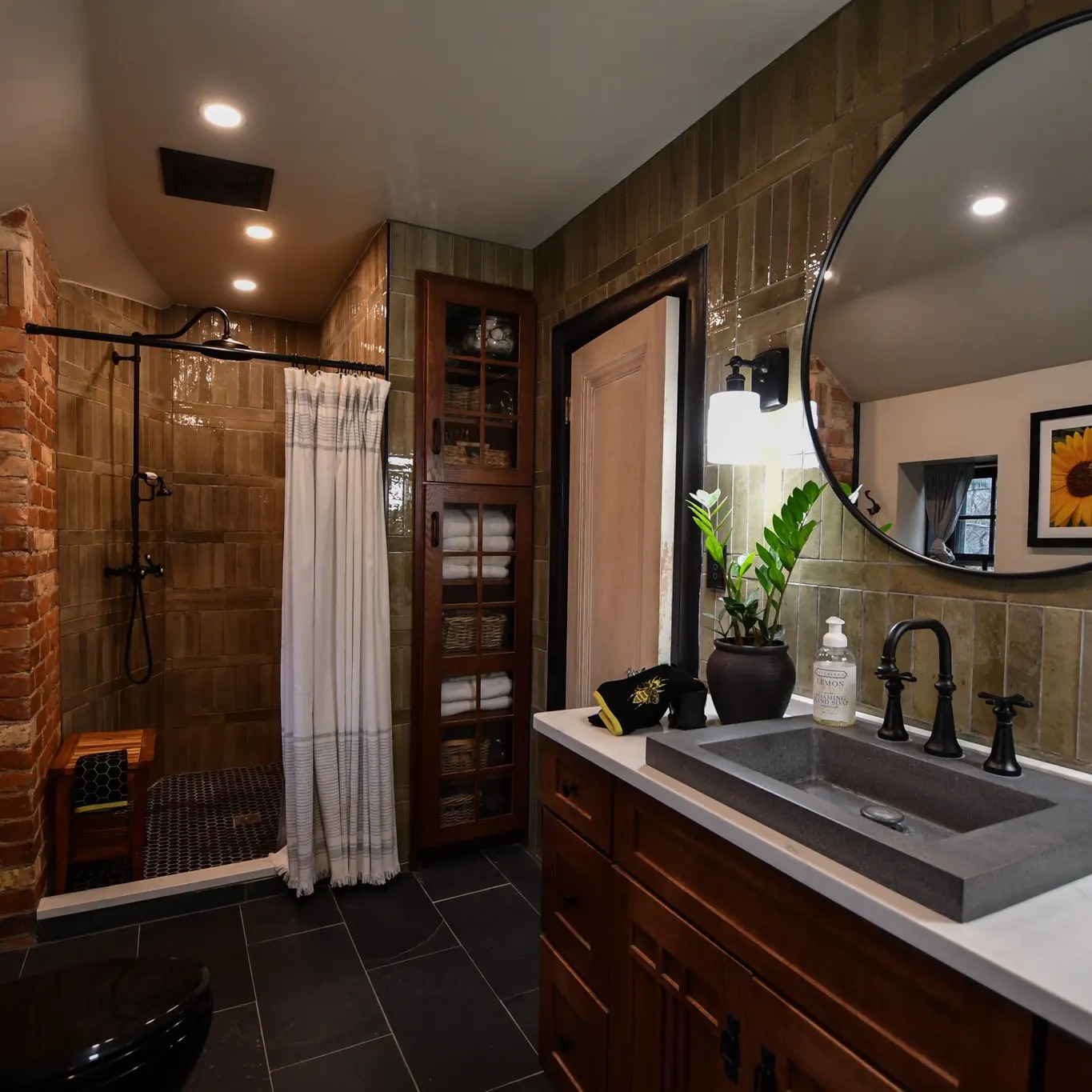 A newly renovated bathroom with custom tilework and vanity